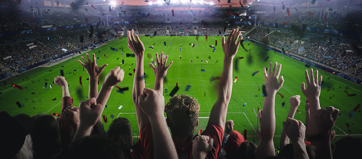establishing,shot,of,fans,cheer,for,their,team,on,a
